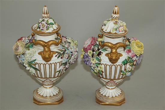 A pair of John Bevington floral encrusted twin handled vases, late 19th century, 24.5cm, damage to covers